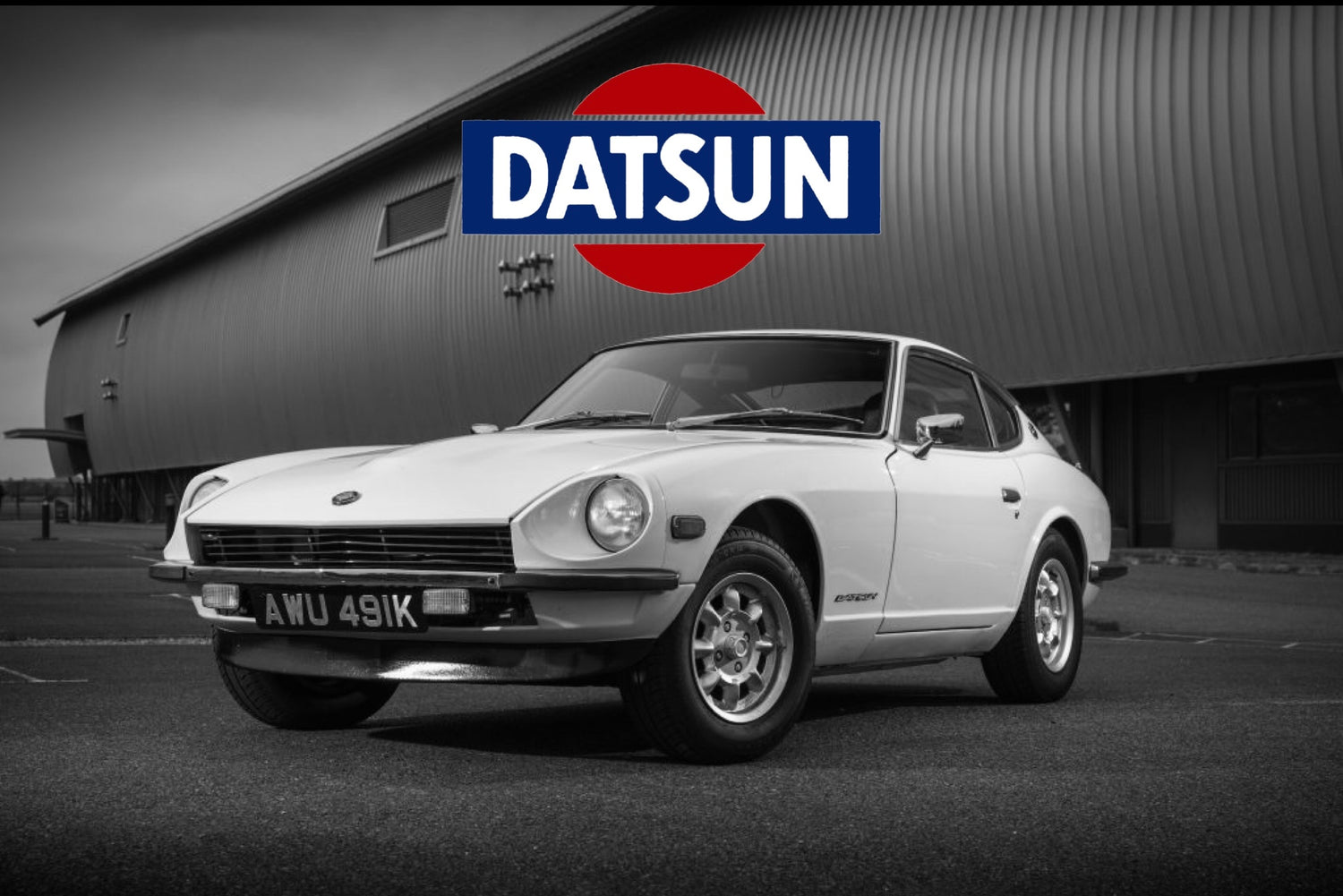 Datsun 240z in black and white with datsun logo above
