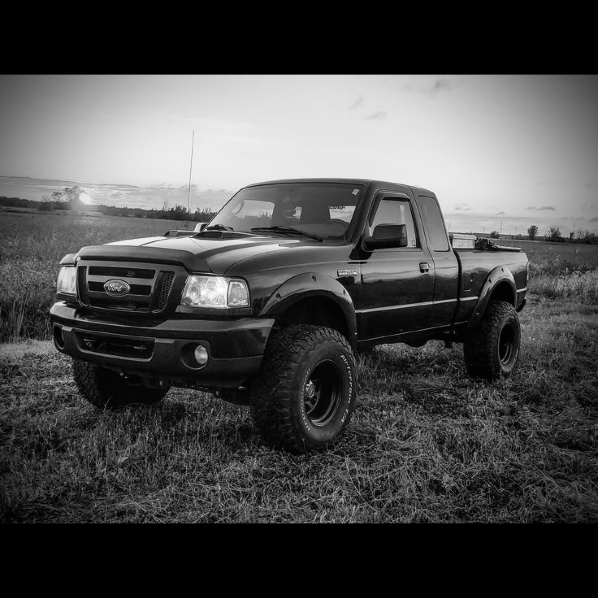 a second generation Ford Ranger in a field in black and white